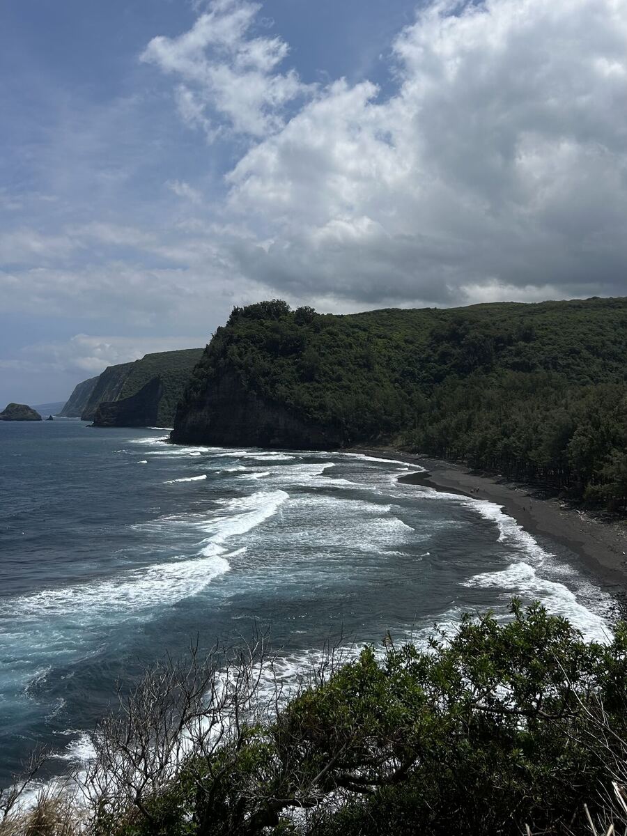Sea cliffs and a black-sand beach